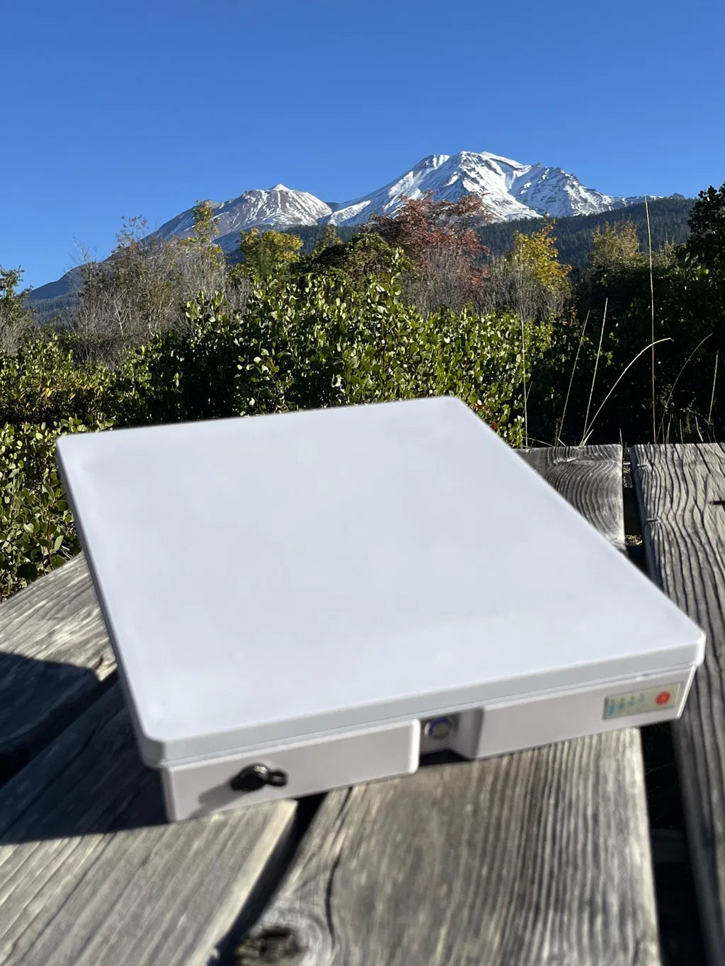 Customer Mini and Ennzia battery setup on a table with mountains behind
